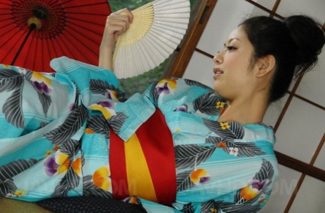 Japanese lady Hana does away with a kimono before masturbating and giving a BJ