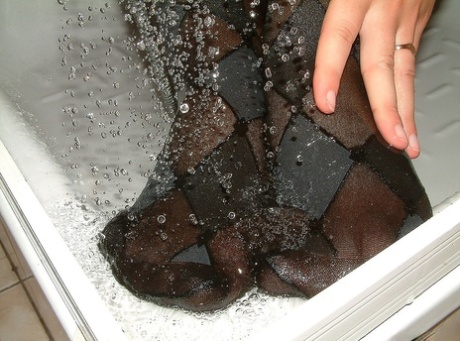 Brunette solo girl Kasia takes a shower in a black bra and sexy pantyhose