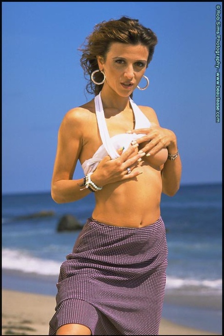 Maeva Exel descobre as suas mamas firmes antes de um close-up vaginal na praia