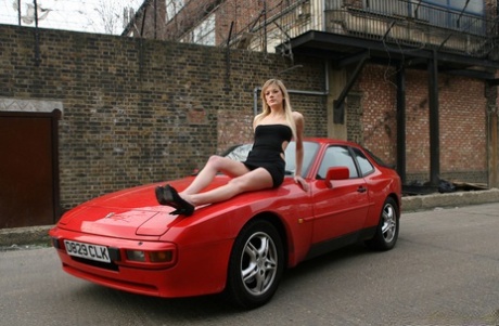 Leggy blonde Addison goes topless on a red sports car in an industrial area