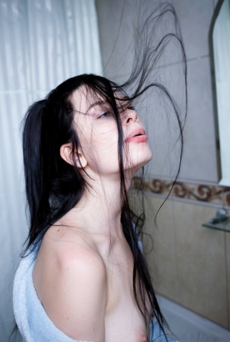 Dark haired teen Ariana Mun gets naked while brushing her teeth