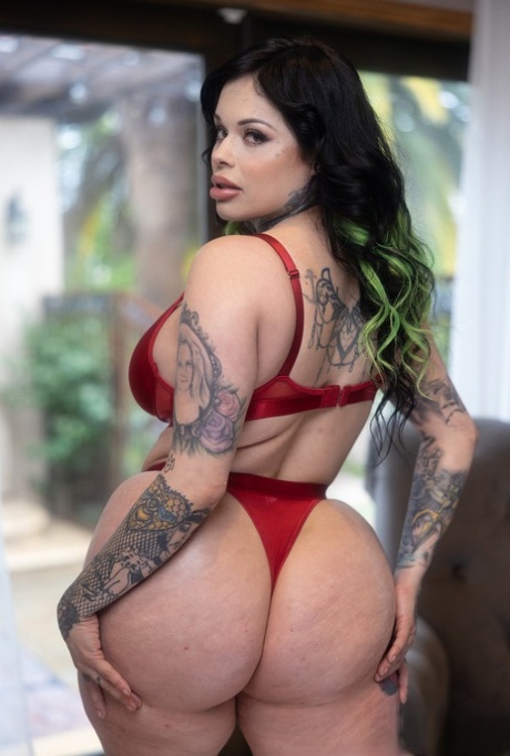 Tattooed Latina MILF Xwife Karen poses by herself before fucking on a bed