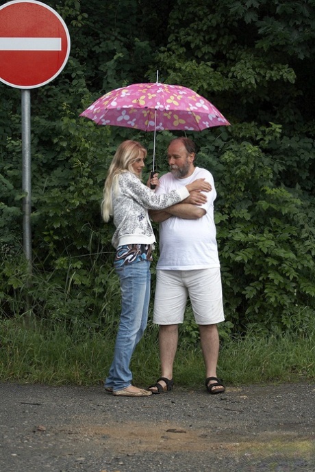 Sexy blonde teen dries off an old man caught in the rain and fucks him too