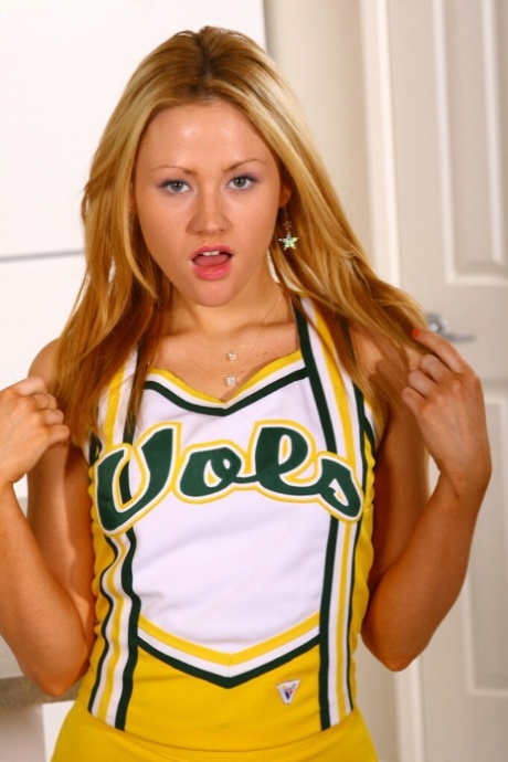 De tienercheerleader stelt katoenen slipje bloot alvorens haar vlotte pussy te tonen