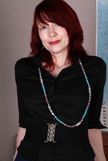 Redhead mature teacher undressing and exposing her goods in the classroom