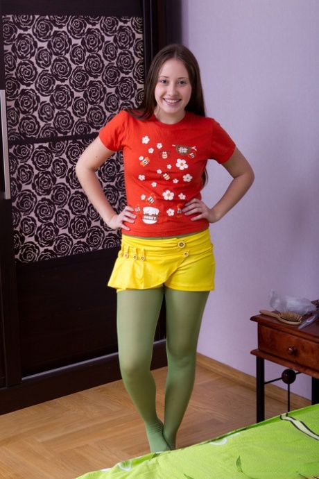 Teen Flora gets rid of her yellow skirt and stockings and shows bushy beaver