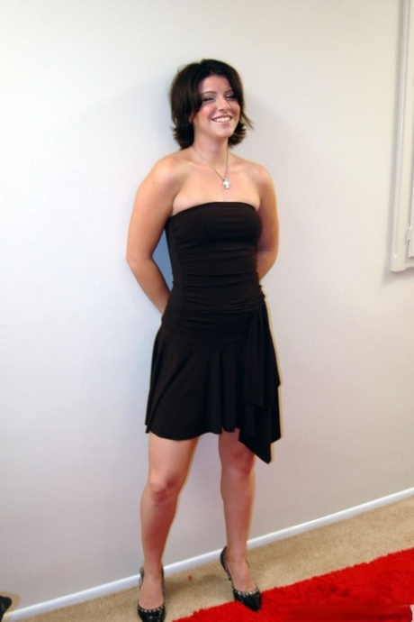 Brunette chick takes off her black dress prior to accepting a facial