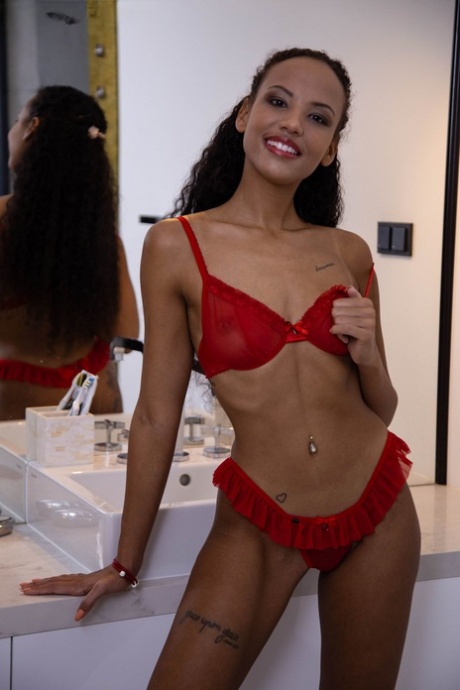 Petite ebony teen Romy Indy exposes her slim body and poses in a tub