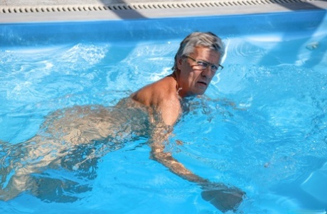 Gay grandpa gives a handsome twink a blowjob and rimjob at the pool