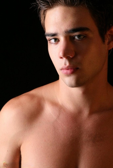 Brunette twink Zack Randall rubs his balls and strokes his hairy dick