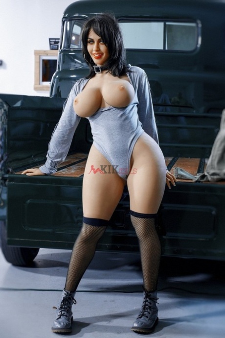 Hot brunette sex doll Shanel shows her big tits and spreads her pussy in a car