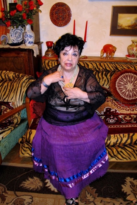 Playful short-haired granny Hormonaria shows her saggy tits while changing