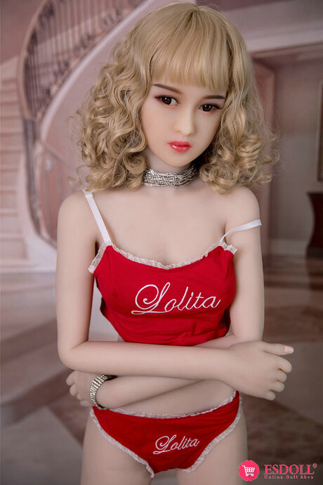 Adorable blonde sex doll gets naked upon a stool in frilly white socks